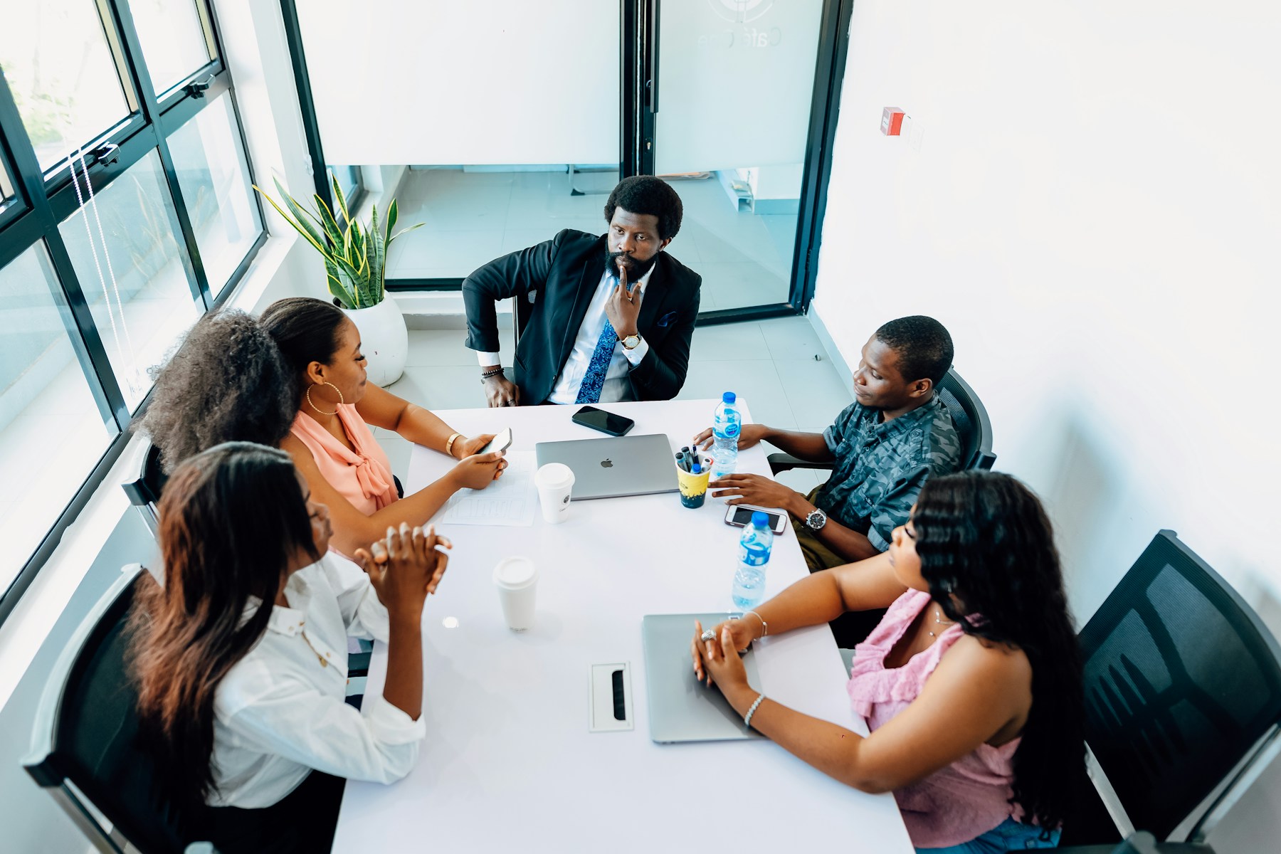 Black business professionals collaborating around a conference table in a modern office